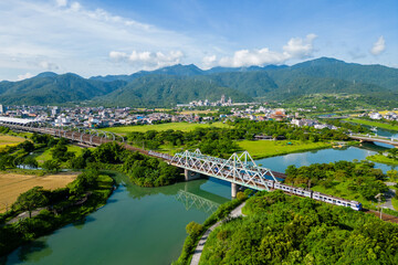Train pass the iron bridge at dongshan river eco park in yilan, taiwan