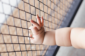 Children Hand With Steel Cage background for advertisement and wallpaper in baby safety and...