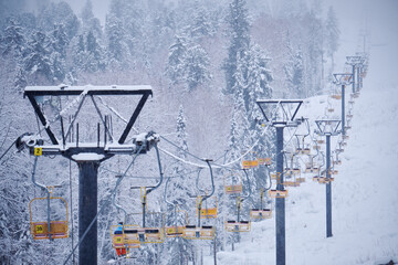 Teletsky Altai winter mountain ski resort near Iogach. Elevator on mount and forest background...