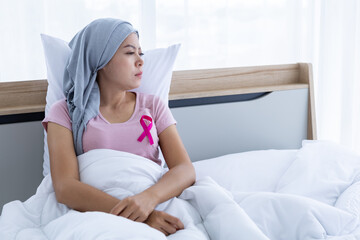 a asian women disease mammary cancer patient with pink ribbon wearing headscarf After treatment to...