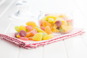 Mix of fruity jelly candy on checkered napkin.
