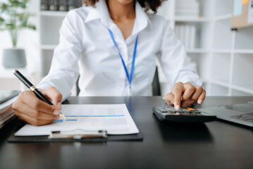 African business woman using laptop computer at modern office with blurred background