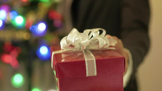 Gift handed to a viewer from a man in business suit