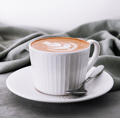 Close up of Cup of coffee with heart flower painted on foam