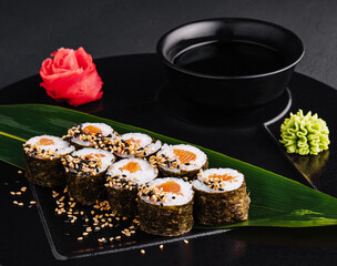 Sushi Rolls Set with Salmon on black plate