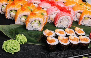 different types of sushi rolls on big plate