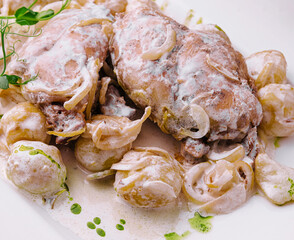 Chicken breast, potatoes and sauce on plate