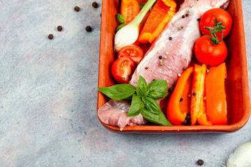 Raw pork tenderloin in a baking dish.