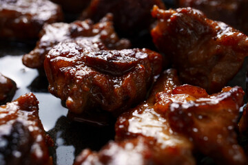 Close-up delicious fried meat in a frying pan, home cooking