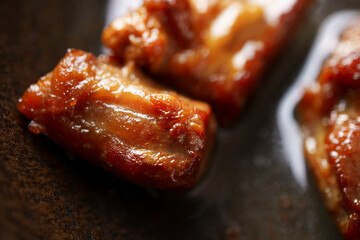 Close-up delicious fried meat in a frying pan, home cooking