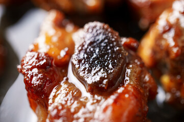 Close-up delicious fried meat in a frying pan, home cooking