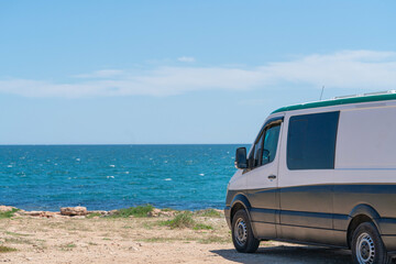 Fototapeta na wymiar House on the wheels / Camper van on the seaside, travel in vacation