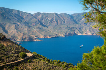 Fototapeta na wymiar Mediterranean sea and sail of yacht on spanish seaside. Blue lagoon