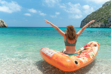 Resting woman on the Mediterranean seaside in blue lagoon
