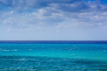 Fototapeta na wymiar View in Greece of mediterranean sea with blue hues and cloudy sky
