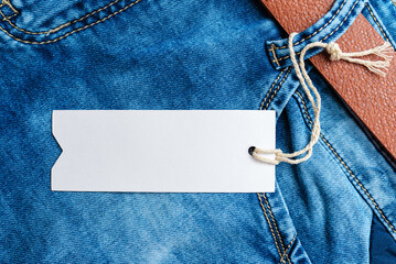 Blank label tag mockup on blue jeans.Blue Denim Jeans,belt,jeans pants with leather...