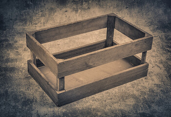 Wooden box with dry grass on grunge background. Toned.