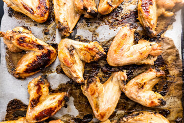 Chicken wings baked on a black background. Food concept. Diet