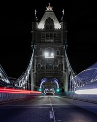 Fototapeta na wymiar Long exposure shot of the light trials along the bridge at night