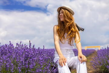 beautiful woman in lavender field.young female on decorative white bike bicycle against cloudy...
