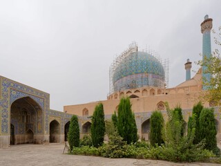 Historic Great Mosque of Isfahan in Iran with trees in the foreground