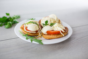 fried in batter sandwiches with tomatoes and mozzarella in a plate with herbs