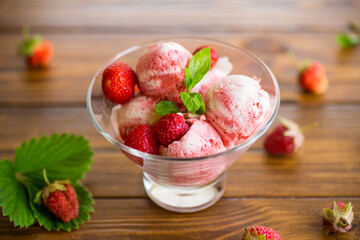 Balls of homemade strawberry ice cream in a bowl