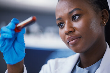 Science, blood vial and female scientist in a lab working on a medical experiment, test or exam....