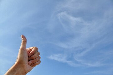 Person's arm extended skyward, displaying the number one with his fingers