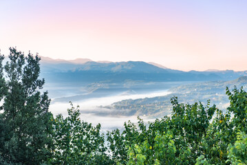 Fototapeta na wymiar Italian Landscape on the Countryside with Fog at Sunrise in Basilicata, in the South of Italy