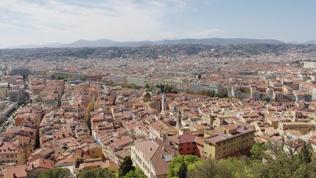 Drone footage over traditional roof houses on Nice, France with blue cloudy sky
