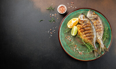 Baked Dorado Sea Bream fish on plate. Healthy food concept. place for text, top view