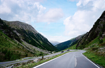 Asphalt road in Alps mountains. Road trip concept. Beautiful landscape.