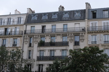 Fototapeta na wymiar Paris building façades, characteristic roofs, and more.It gathers many types of buildings, coming from various districts of the city; all passing through various settings of the day.