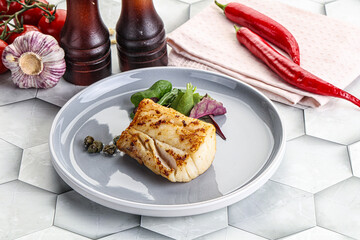 Roasted cod fish steak with salad