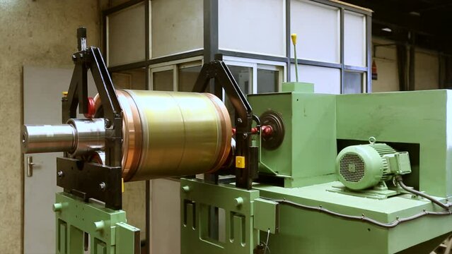Huge electric motor spinning at the production shop of the factory.