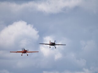 Fototapeta na wymiar Two aerobatic planes flight together in an air show