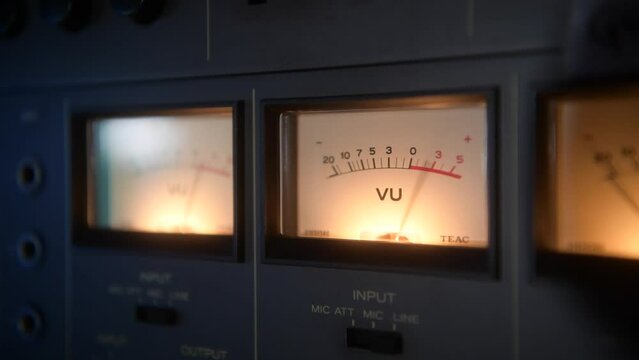 Close up view of a tape recorder VU meters pumping with the music