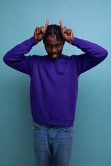 funny american young man with dreadlocks in a blue sweatshirt