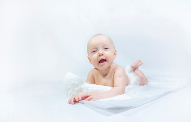 a baby with a hemangioma on his neck lies on a white background. banner with a copy space. profile of a little bald baby girl. the kid looks to the side