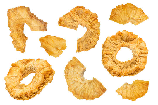 Dried pineapple slices on a white isolated background. Dried pineapples of different sizes, the concept of drying fruits at home. For inserting into a design, project or for packaging labels.