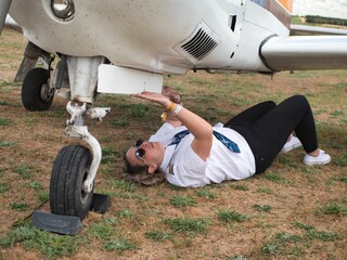 Female pilot checking her plane