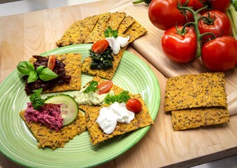 Plate of freshly-baked crispbread with various toppings.
