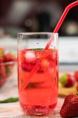 Summer refreshing cocktail with strawberries and fresh mint and ice cubes. Close-up. Selective focus.