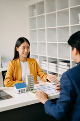 Salesman Hands On House Model , Small Toy House Small Mortgage Property insurance and concepts real estate.