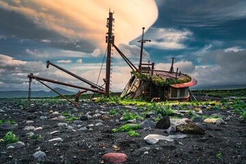 Surreal sunrise casts its light on an abandoned fishing boat in Umnak, Alaska