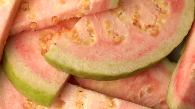 Closeup of spinning tasty and organic slices of guava