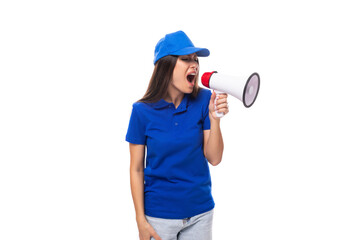 pretty well-groomed young promoter woman in a blue cotton t-shirt and cap uses a loudspeaker to announce promotional offers