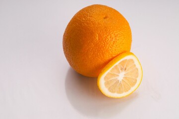 Bright orange citrus fruit against a white background.