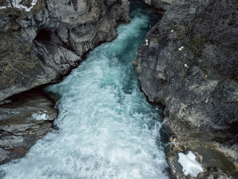water that flows through the lech fall and is on its way towards the valley. Photographed from a bridge that leads over the Lech. Recorded in winter.